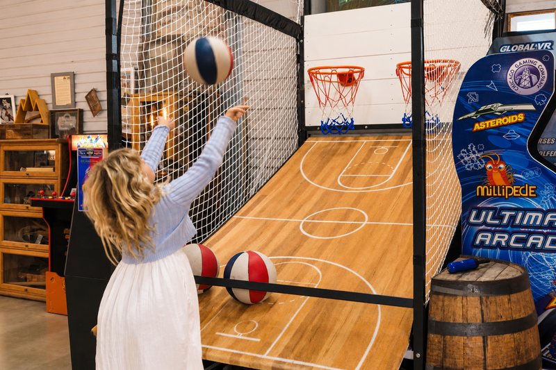 A girl shooting at the two hoops of Legend's Stadium Basketball.